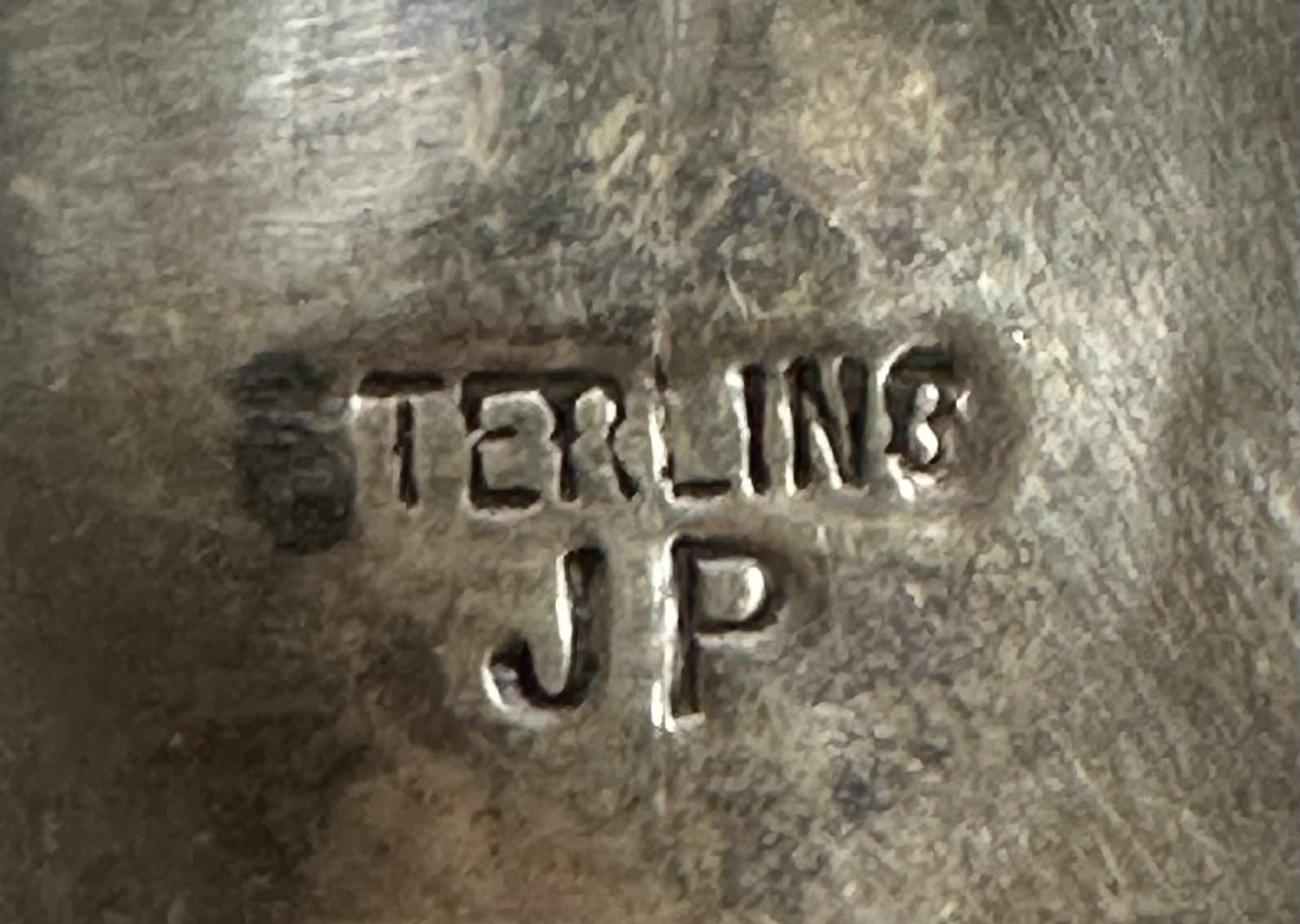 Hallmark of Juan Pino, reading JP
