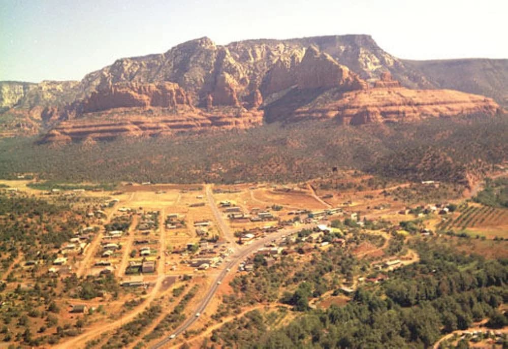 1970 aerial colour photograph of Uptown Sedona, Jordan Road and the highway beneath the red rock cliffs