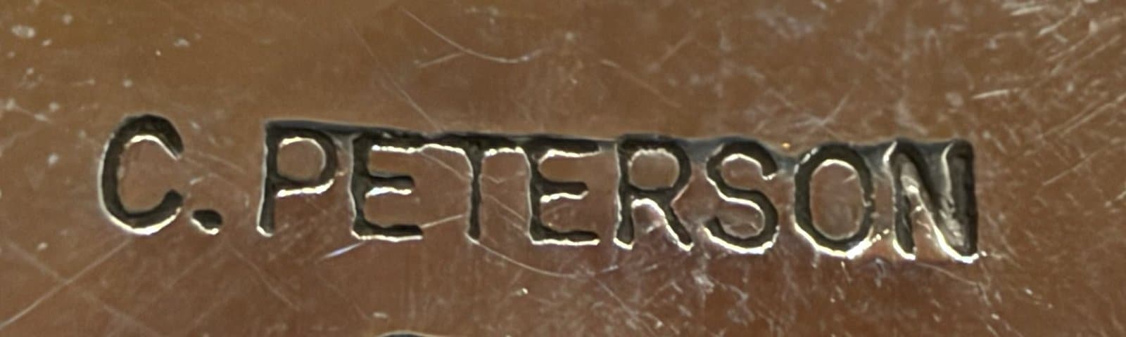 Hallmark of Calvin Peterson, reading C.PETERSON, with a lizard symbol