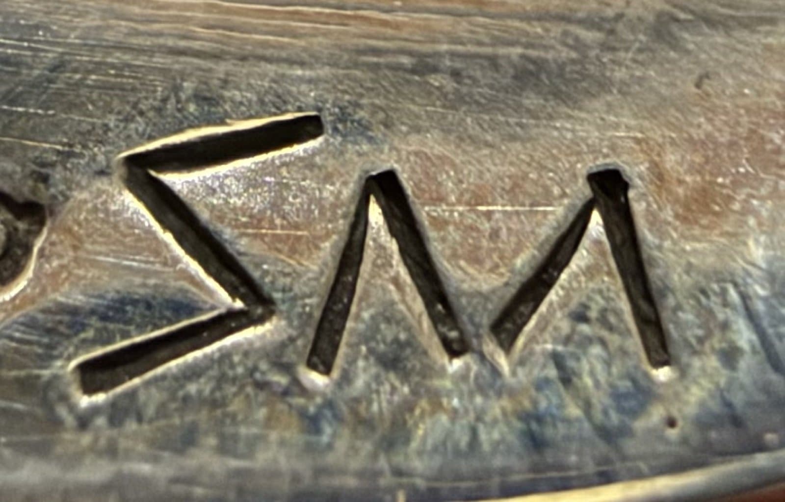 Hallmark of Delfred "Sparks" Masawytewa, reading SM, with a angular stamped initials "SM" symbol