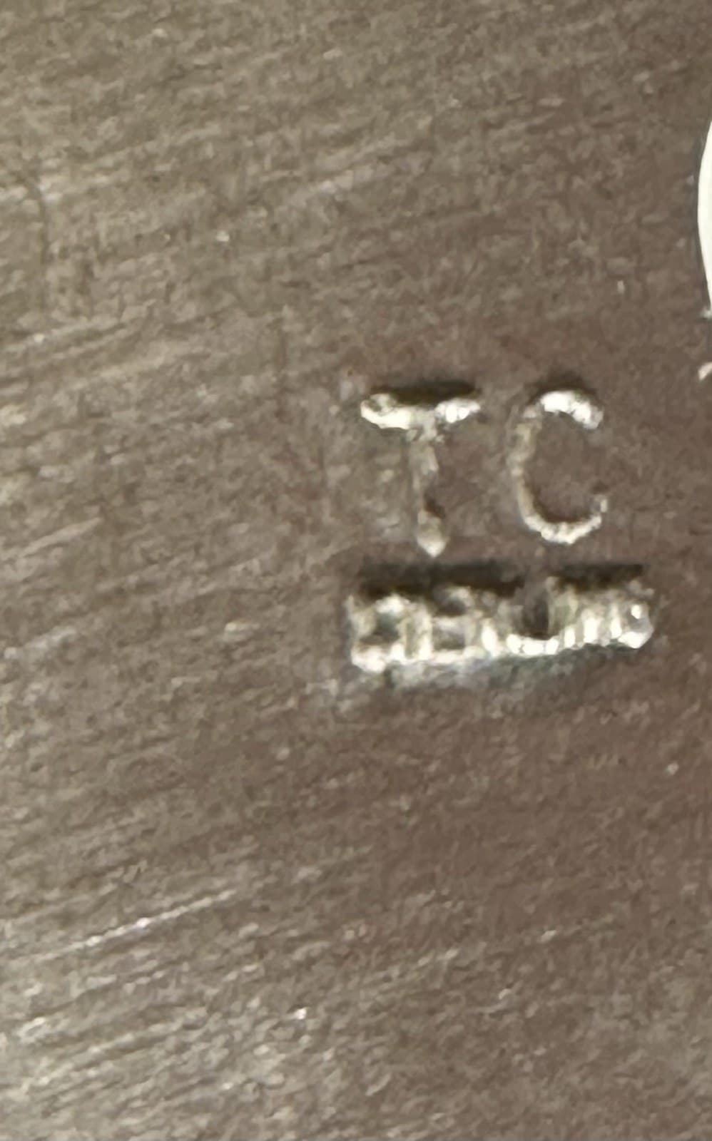 Hallmark of Tommie Charlie, reading TC, with a Tc symbol